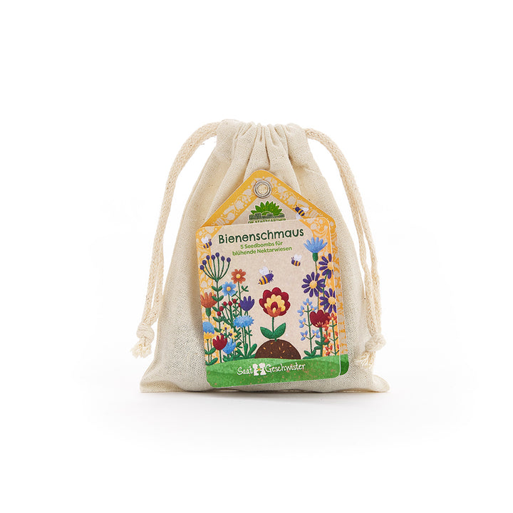 Sachet de graines, étiquette « Bee Feast » et illustrations de fleurs colorées.
