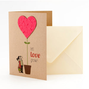 Carte de vœux avec un motif de cœur et le texte « laissez l'amour grandir ! », à côté une enveloppe.