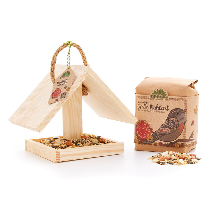 Mangeoire à oiseaux avec nourriture pour oiseaux comme idée cadeau